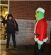 People Looking at the Grinch Figure